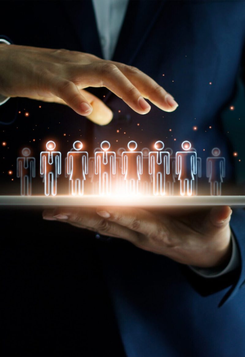 Businessman holding tablet and management group of people in his hand. Virtual icon of social network. Business technology concept.